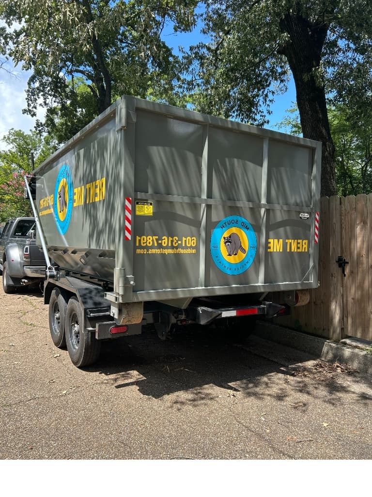 Mid South Dumpster Rentals blue roll-off container delivered on a residential driveway in Flowood, Mississippi (Rankin County) — Lakeland Drive corridor