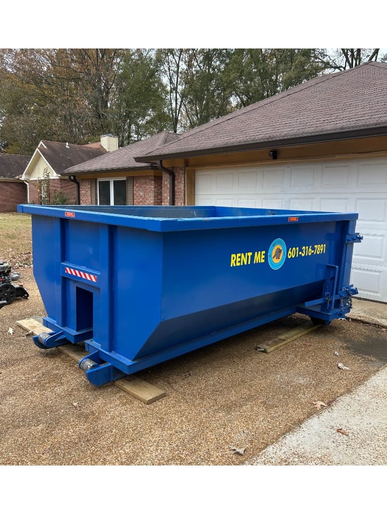 Roll-off dumpster on a residential job site in Central Mississippi during a bathroom remodel