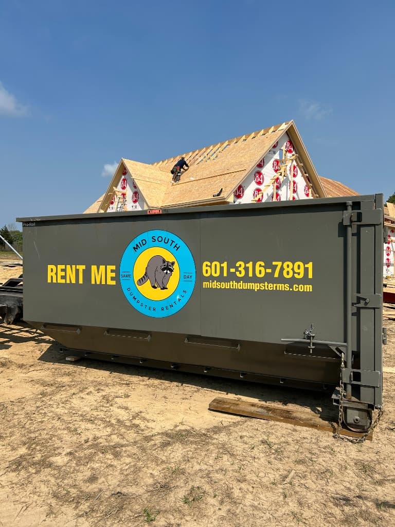 Roll-off construction dumpster on a new-build job site in Mississippi