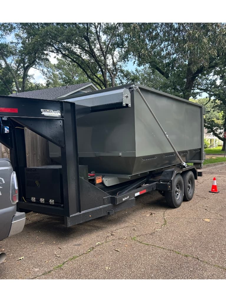 Mid South Dumpster Rentals roll-off container on delivery in Jackson, Mississippi — serving Hinds County residential and commercial customers