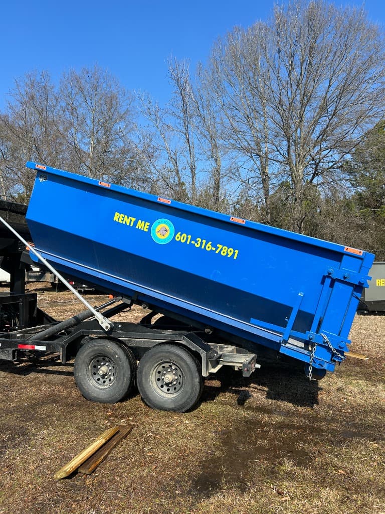 Large roll-off dumpster filled with construction debris on a Central Mississippi project site