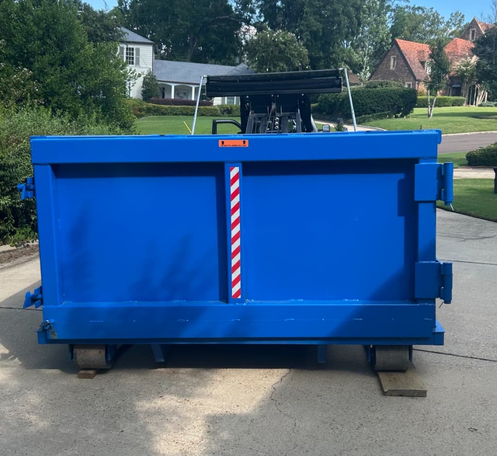 Roll off dumpster rental delivery on a driveway in Canton, MS