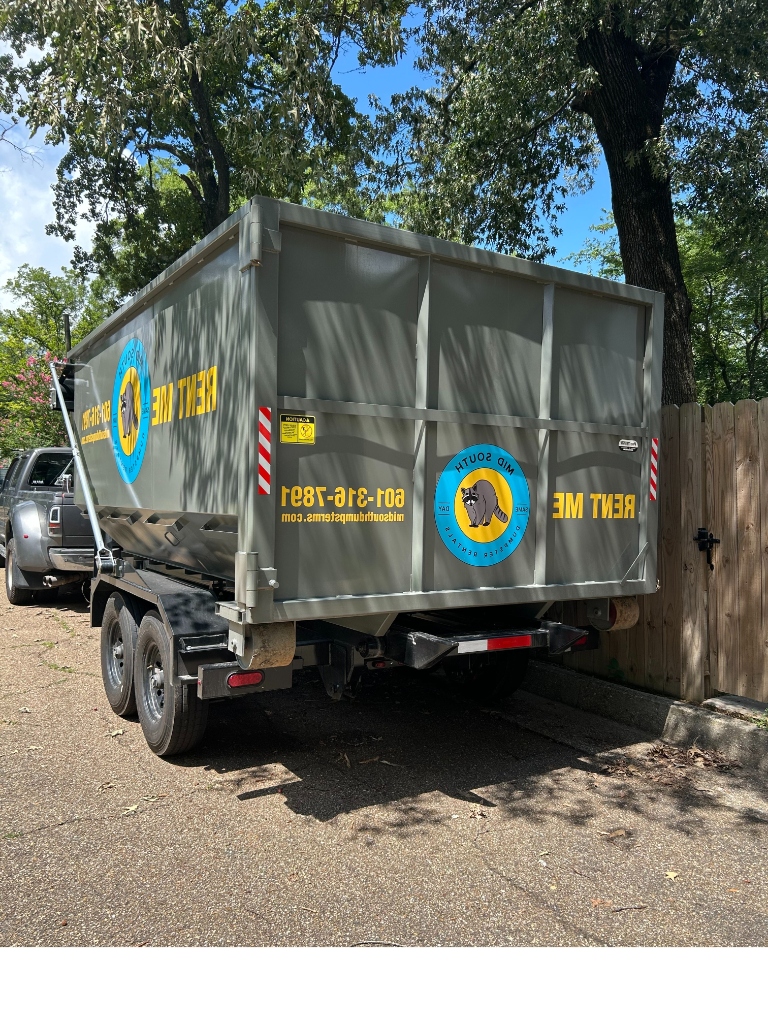 Clean blue roll-off dumpster delivered to a driveway in Central MS for spring cleaning