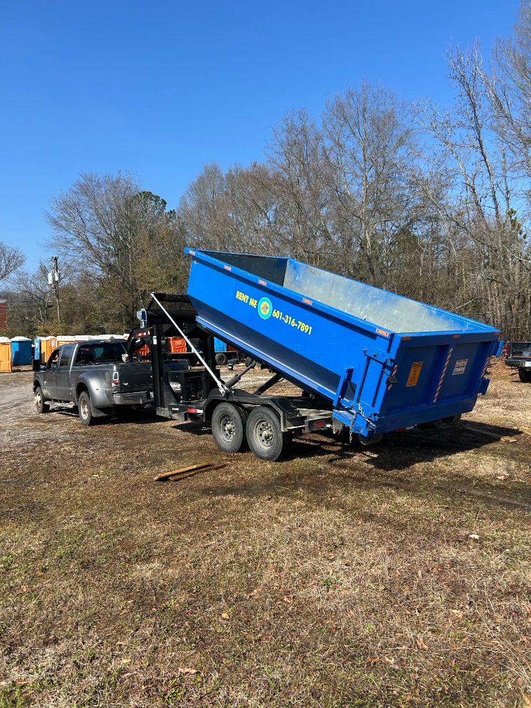 A 10-yard roll-off dumpster fitting perfectly in a typical Jackson MS residential driveway